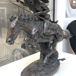 Bronze sculpture of what is believed to be a Cheyenne Native American riding a horse